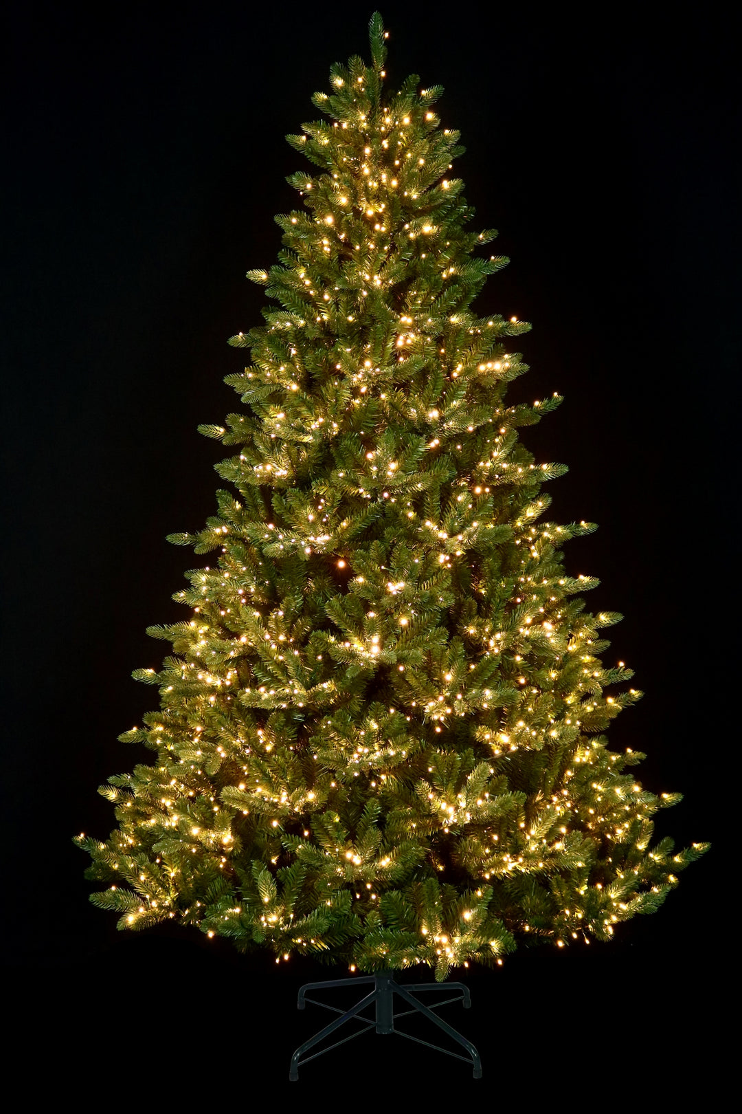 7.5' Cumberland Slim Pre-Lit Christmas Tree, black background, showing clear lights.